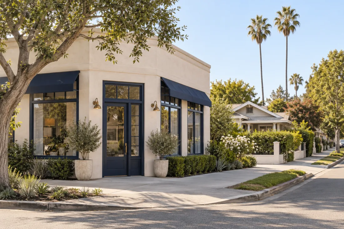 A quiet Los Angeles streetscape with a small commercial building and neighborhood homes